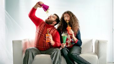 Two geeks eating popcorn